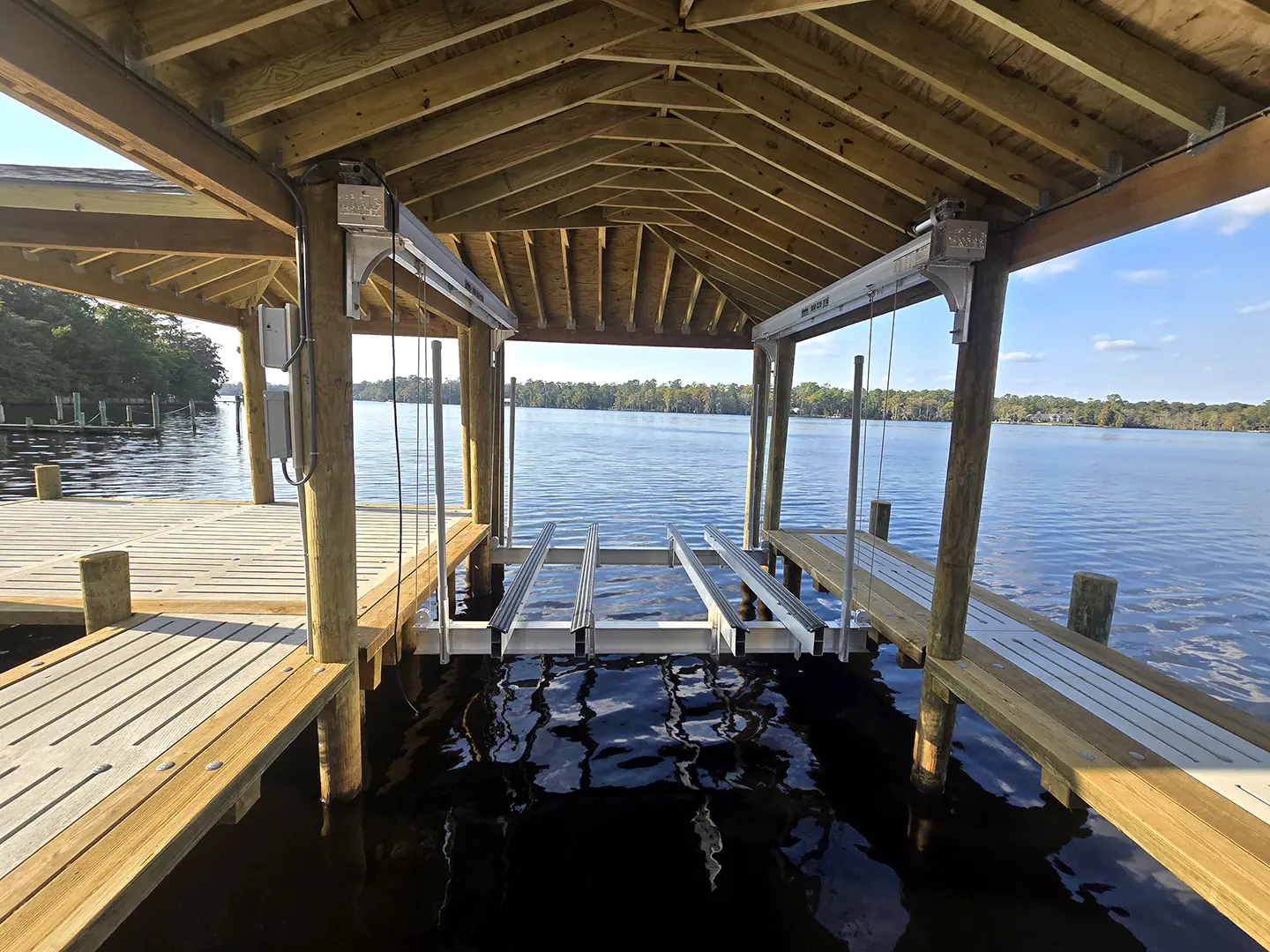 Ultimate Hog Slat Dock with Boathouse, Boat Lift, Jetski Lift, Covered Platform and Lowered Swim/Kayak Platform on Trent River