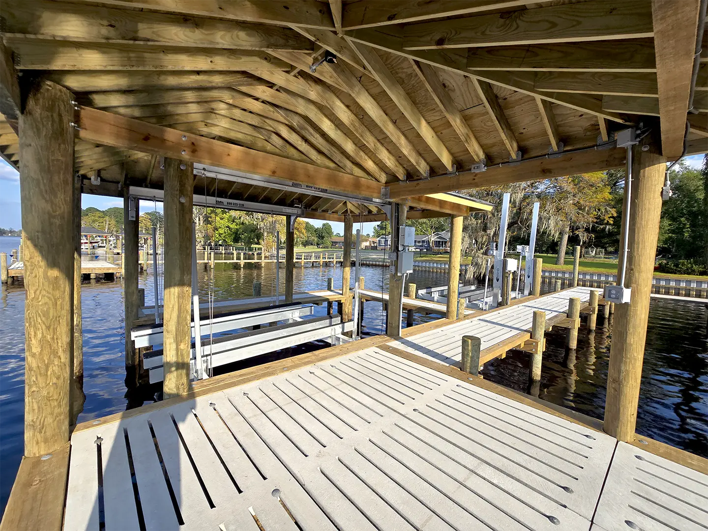 Ultimate Hog Slat Dock with Boathouse, Boat Lift, Jetski Lift, Covered Platform and Lowered Swim/Kayak Platform on Trent River